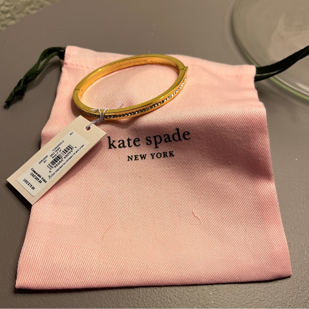Kate Spade gold bangle with channel set crystals